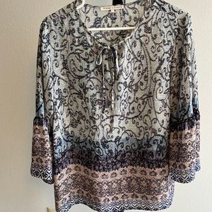 Blouse with 3/4 length bell sleeves, tie at the neck line, polyester